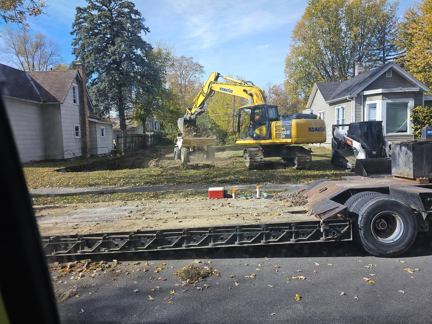 Excavation equipment preparing a residential building site